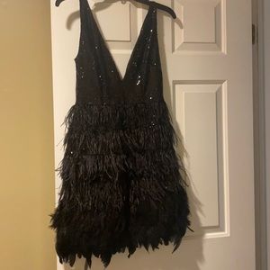 Party dress size small with rhinestones and feathers